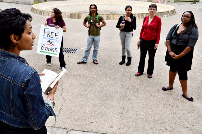 <p>Sheela Jane Menon, graduate student in English, reads a selection from Bless Me Ultima, by Rudolfo Anaya, in a read-in Wednesday on the West Mall. The event was hosted to protest the banning of books in an Arizona public school district as well as to fight for the continuation of ethnic studies at UT. </p>