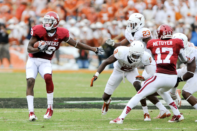 <p>Justin Brown gets past a group of Texas defenders during a 28-yard catch in the second quarter of the longhorns' 63-21 loss to Oklahoma on Saturday. Quandre Diggs' attempt to strip Brown was unsuccessfull, while Carrington Byndom and Mykkele Thompson made futile attempts to tackle Brown on one of many long gains made by the Sooners in theis year's game.</p>
