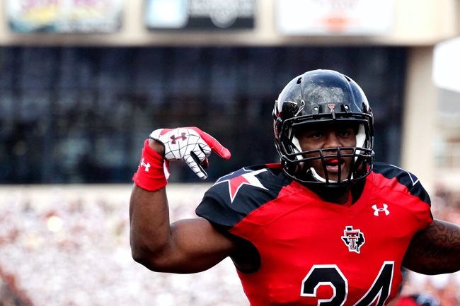 <p>Texas Tech running back Kenny Williams celebrates his first quarter touchdown with a horns down sign. It is a sign that Mack Brown labeled on Monday as disrespectful and a double standard after Mike Davis was penalized for holstering guns at the Tech crowd.</p>
