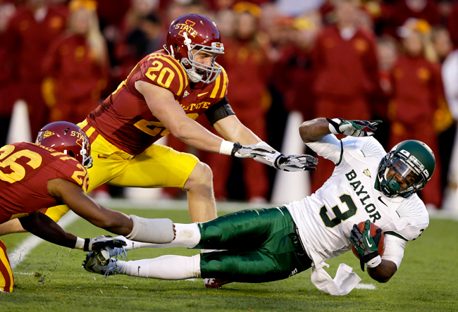 <p>Baylor wide receiver Lanear Sampson is tackled by Iowa State defensive back Deon Broomfield and linebacker Jake Knott (20) after making a reception during the first half of a game, Saturday, Oct. 27 in Ames, Iowa. Iowa State won 35-21.</p>
