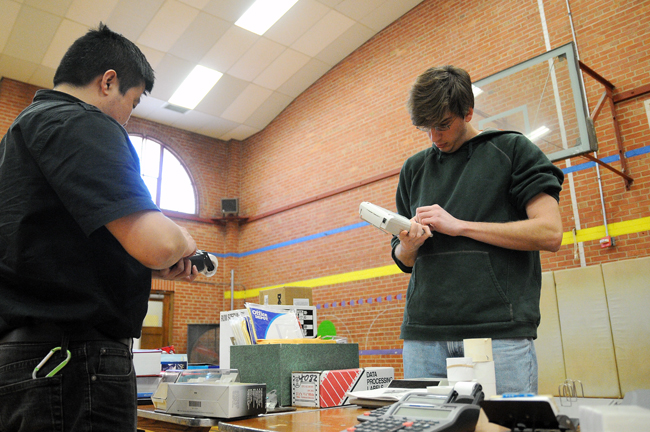 <p>John Thompson, an organic chemistry graduate student, chooses items to buy from the office supply sale in the Anna Hiss Gym.  The office supply swap is selling used products to students for discounted prices.</p>
