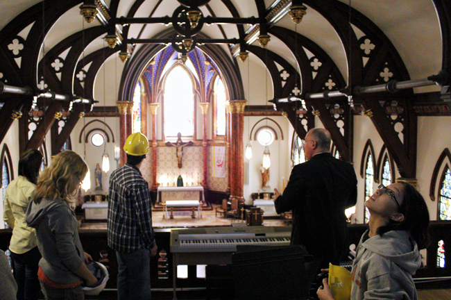 <p>A group of UT engineering students observe as the Rector at St. Mary’s Church in Downtown Austin Fr. Albert Laforet provides an architectural history of the cathedral Friday afternoon.</p>
