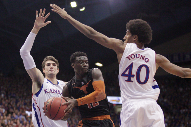 <p>Texas point guard Myck Kabongo drives through Kansas' Kevin Young and Jeff Withey in the first half.</p>
