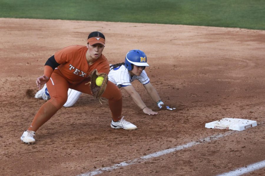 First+baseman+Mary+Iakopo+catches+a+ball+thrown+to+her%2C+trying+to+halt+her+opponents+efforts+of+returning+to+first+base.+Texas+played+McNeese+State+at+Red+%26+Charline+McCombs+Field+on+February+16%2C+2022.