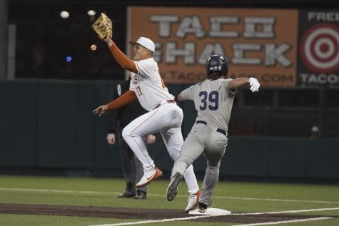 Texas baseball first basemen Ivan Melendez uses his glove to help secure the out at first base. Texas played Rice at UFCU Disch-Falk Field on Feb 18, 2022.