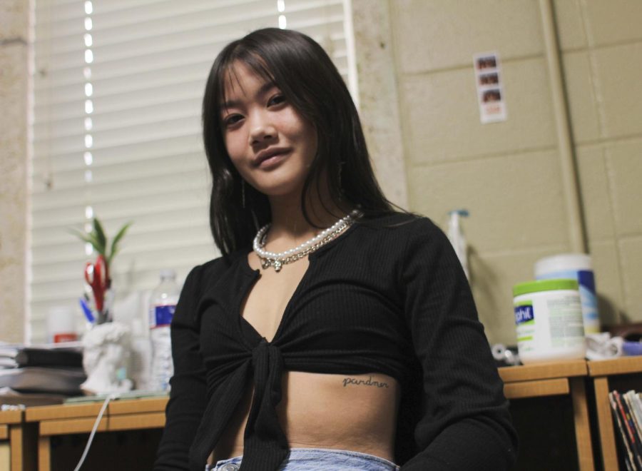 Freshman psychology major Emily Tran shows off one of her tattoos in Jester West. She got her tattoos to represent time shared with important people in her life.