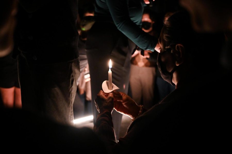 A rally attendee holds a lit candle during the candle lighting at the Beto O'Rourke rally.