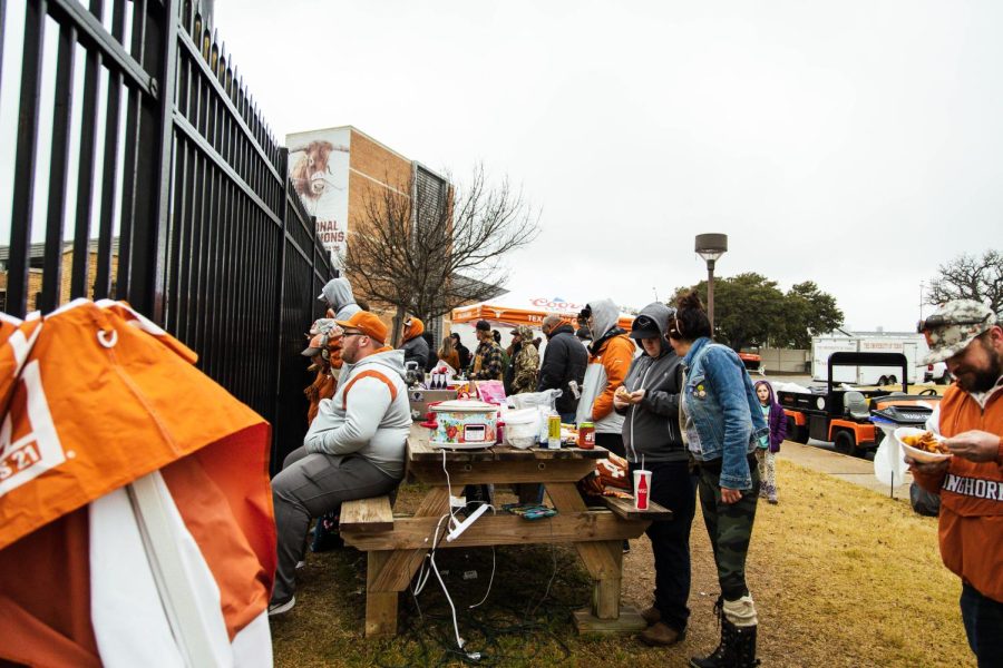 Members of the tailgating group Occupied Left Field stand outside of the UFCU Baseball Stadium on Feb. 26. On Saturday, UT beat Alabama 2-0. 