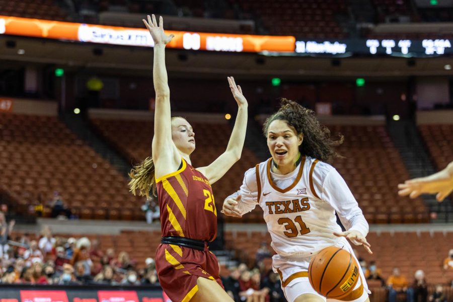UT basketball player Audrey Warren dribbles around an Iowa State player and heads towards the goal. The teams final game of the season is March 5. 