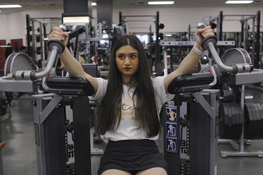 Sophomore finance major Ishika Puri uses a weight machine in Gregory Gymnasium on March 1st. Ishika is passionate about creating a welcoming environment for female students to work out.