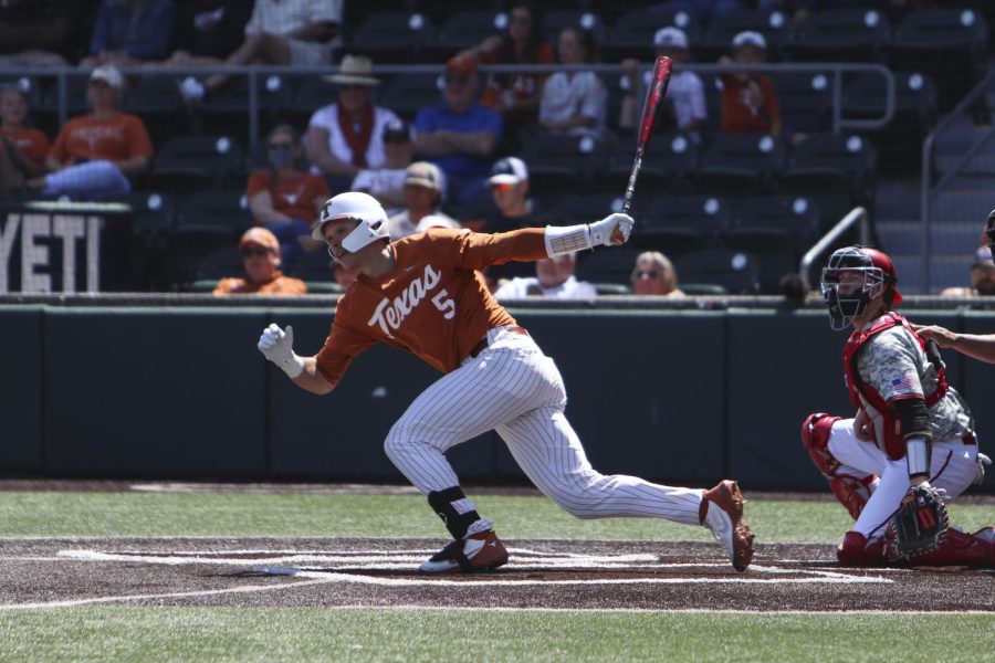 Senior Skyler Messinger hits a fastball at UFCU Disch-Falk Field on March 20, 2022. Messinger  struggled on the field after transferring from Kansas, and is now emerging from his slump.