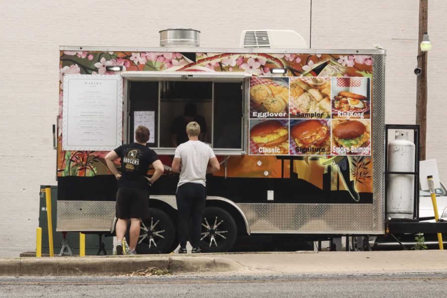 Two customers wait for their sandwich order from the Wabara food truck on Whitis Ave. Wabara recently had its grand opening in the food truck lot near the on-campus Target.