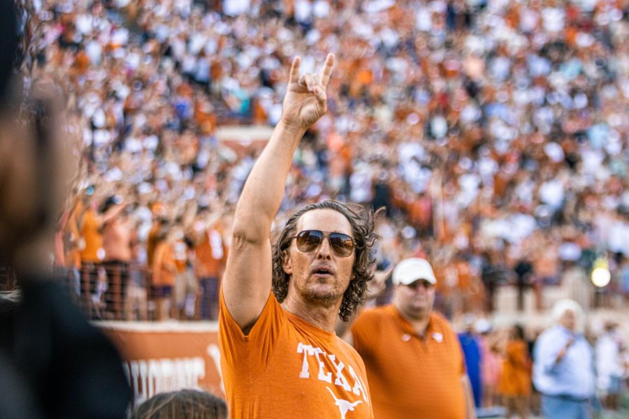 Matthew McConaughey throws up a hook em before Texas Footballs spring game on April 23. At the spring game, UT football players scrimmaged against their own teammates to prepare for the fall season.