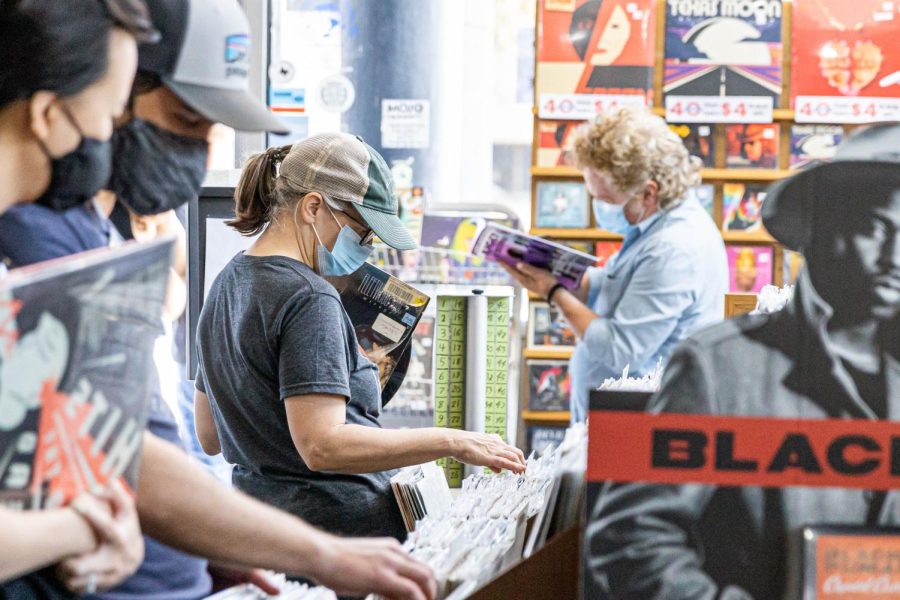 A person shuffles through vinyls at Waterloo Records 40th anniversary celebration. On April 1, singer and songwriter Ray Wylie Hubbard performed at this event.