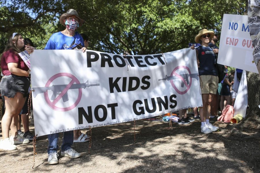 Protesters hold up a sign at the March for Our Lives protest on June 11, 2022. The protest was held in reaction to the school shooting in Uvalde, Texas, in May. 