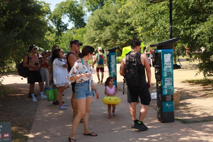People line up outside Barton Springs to buy tickets to swim. 
