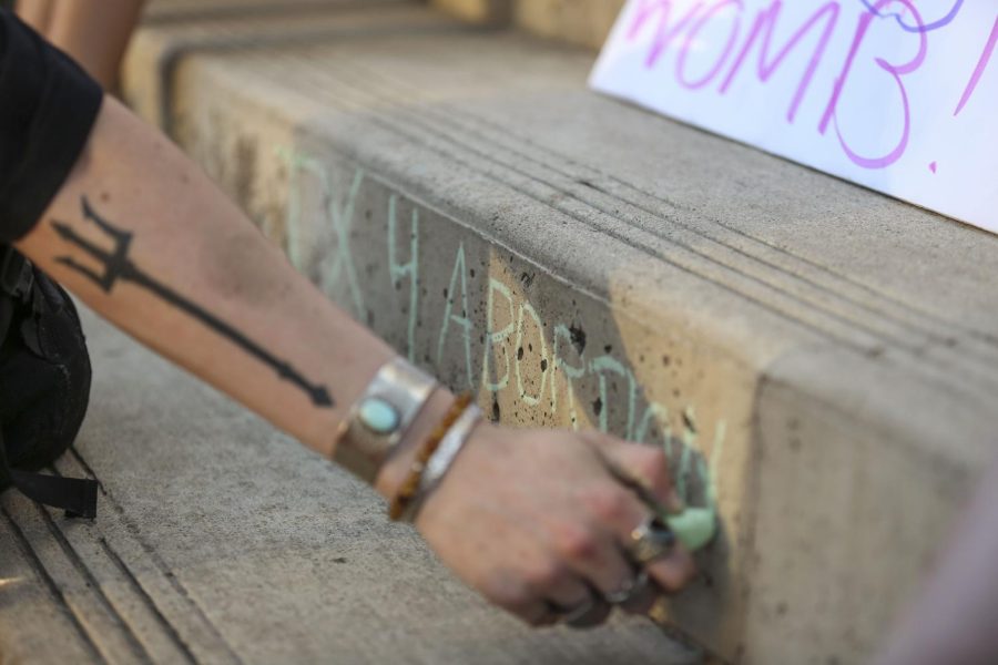 A protester writes TX 4 Abortion on the steps of the Federal Courthouse on June 24. 
