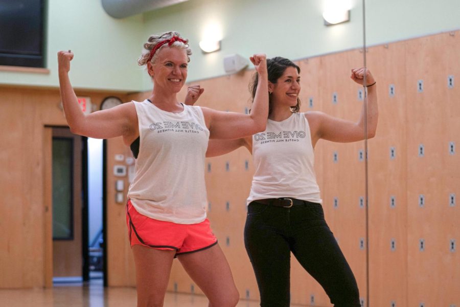 General Manager of Castle Hill Fitness Lori Johnson (left) and Marketing Manager Rebecca Brumberg (right) flex in front of a mirror in one of the fitness center’s studios. Castle Hill Fitness celebrated its 20th anniversary with games and free fitness activities on Oct. 12, 2022.