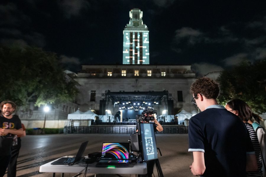 Students play Tower Tumble as it is being projected in real time onto the UT Tower