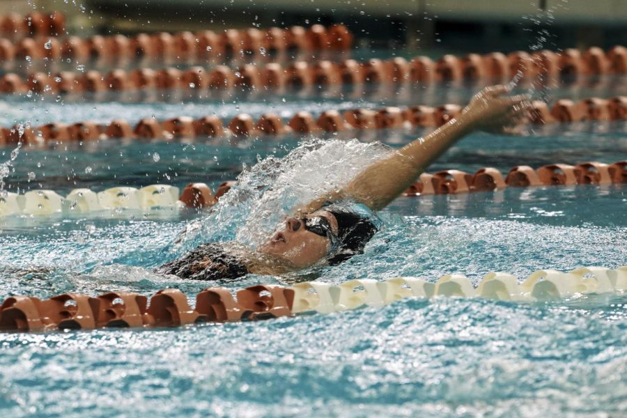 Junior Olivia Bray swims the backstroke at a swim meet against Texas A&M and Indiana on Oct. 21, 2022.