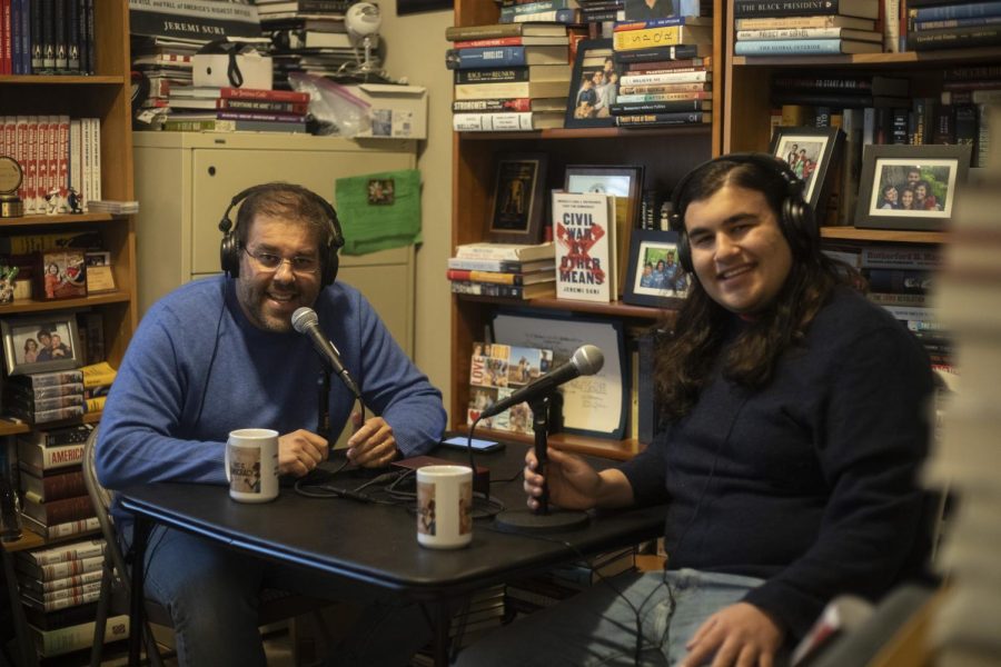 Dr. Suri and his son, Zachary, sit at the desk where they record their podcast, This Is Democracy, on Jan. 27, 2023. 