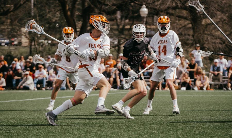 A Texas Lacrosse players attempts to score against Texas A&M at Clark Field on Feb. 19, 2022. Texas defeated Texas A&M 10-9.