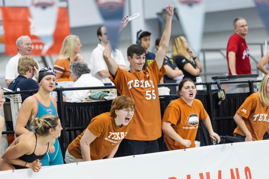 Texas swimmers cheer as their teammates compete in the Big 12 Swimming and Diving Championship at the Lee and Joe Jamail Texas Swimming Center on Feb. 25, 2022. The University of Texas was named Big 12 Champions for mens and womens events. 
