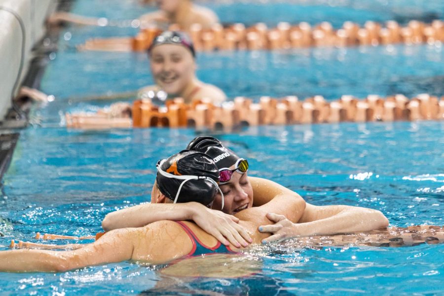 Texas womens swimmers hug after competing in the Big 12 Swimming and Diving Championship at the Lee and Joe Jamail Texas Swimming Center on Feb. 25, 2022. The University of Texas was named Big 12 Champions for mens and womens events. 