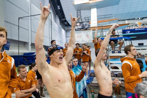 Texas swimmers cheer as their teammates compete in the Big 12 Swimming and Diving Championship at the Lee and Joe Jamail Texas Swimming Center on Feb. 25, 2022. The University of Texas was named Big 12 Champions for mens and womens events. 