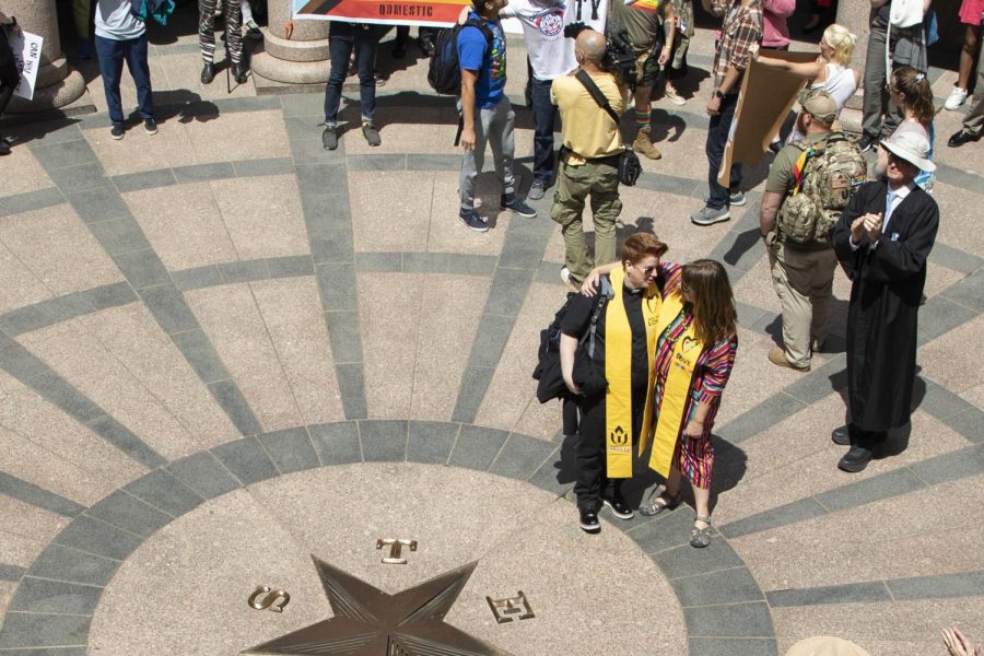 Two protestors embrace at a Trans Rights Rally in Austin, Texas on March 27, 2023.