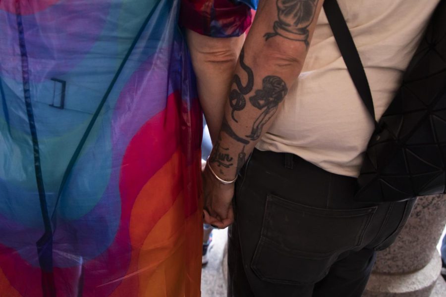 Two protestors hold hands during a rally at the Texas state capitol on March 27, 2023. The rally was held in protest of House Bill 1686.