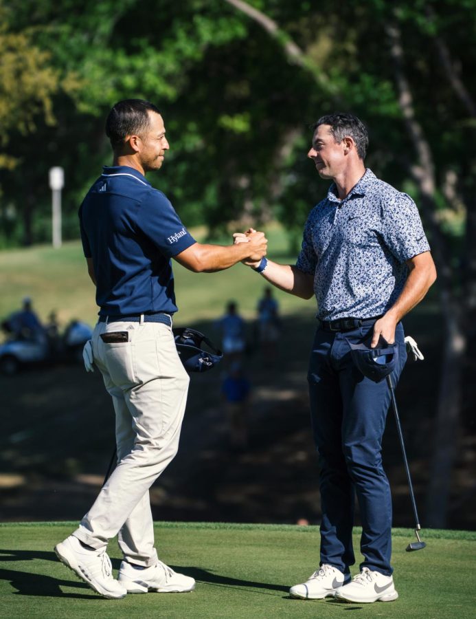 Professional golfers Rory McIlroy and Xander Schauffele shake hands at Dell Match Play on March 25, 2023.