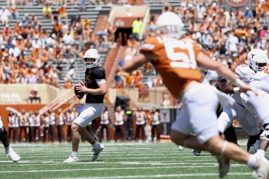 Quarterback+Quinn+Ewers+attempts+to+move+the+ball+downfield+during+the+Orange+and+White+Game+at+DKR+Texas+Memorial+Stadium+on+April+15%2C+2023.