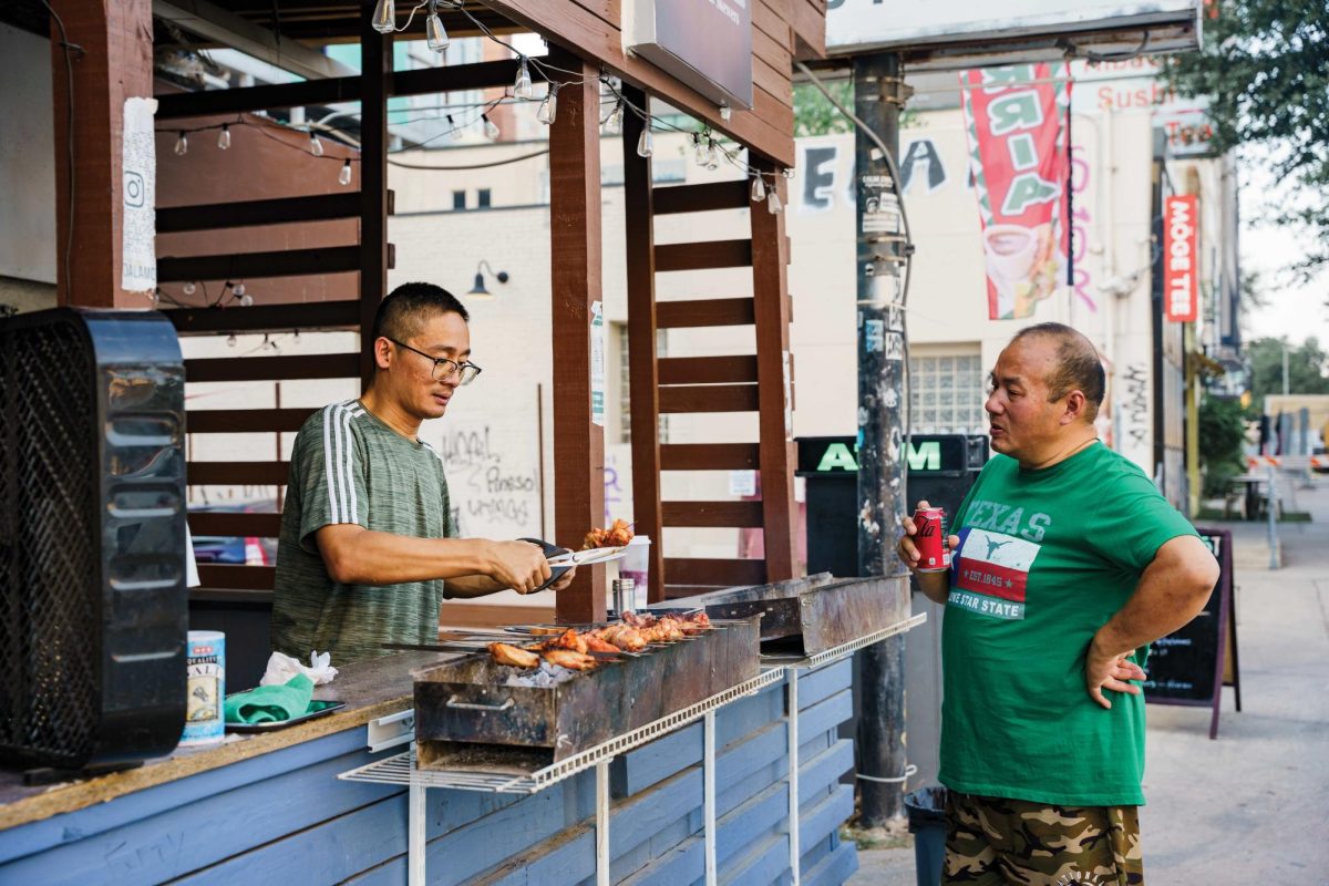 Diego Duan serves Uyghur-style Xianjang kabobs to a customer at Camino Alamo BBQ on Guadalupe Street in Austin, TX on Aug 31, 2023.