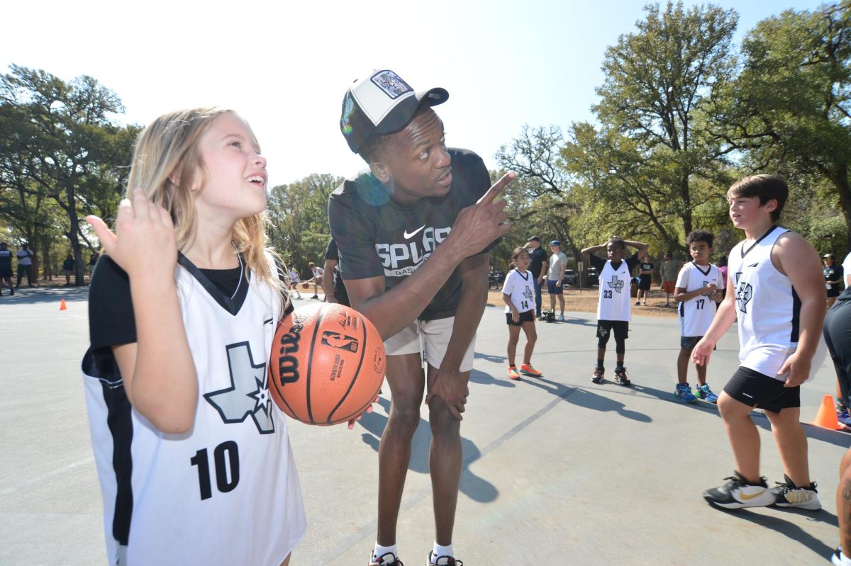 Former Longhorn Sir’Jabari Rice, now with the Austin Spurs, helps host youth clinic, court unveiling