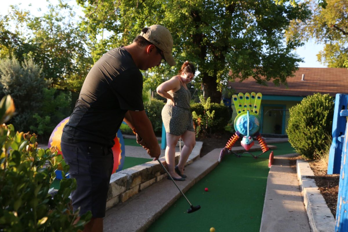A couple plays mini golf at Peter Pan Mini Golf on Sep. 20, 2023. The family-owned business has operated for 75 years.