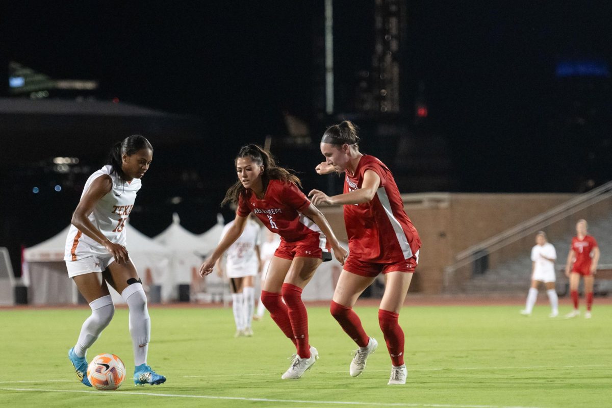 Longhorn forward Trinity Byers plays against Texas Tech defense on Thursday night’s soccer game at the Mike A. Myers Stadium on Sep. 21, 2023.