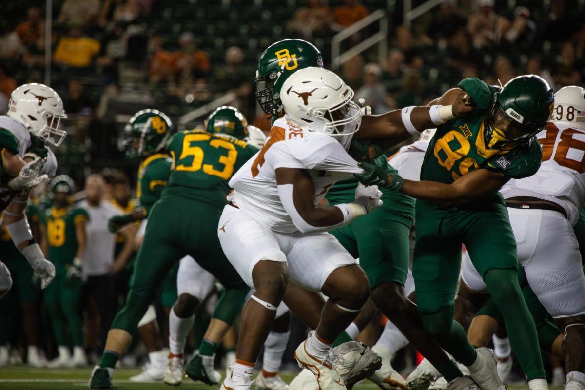 Defensive lineman Jaray Bledsoe shoves a Baylor tight end during the Longhorns game against the Bears on September 23, 2023. Texas won 38-6 in Waco, TX.