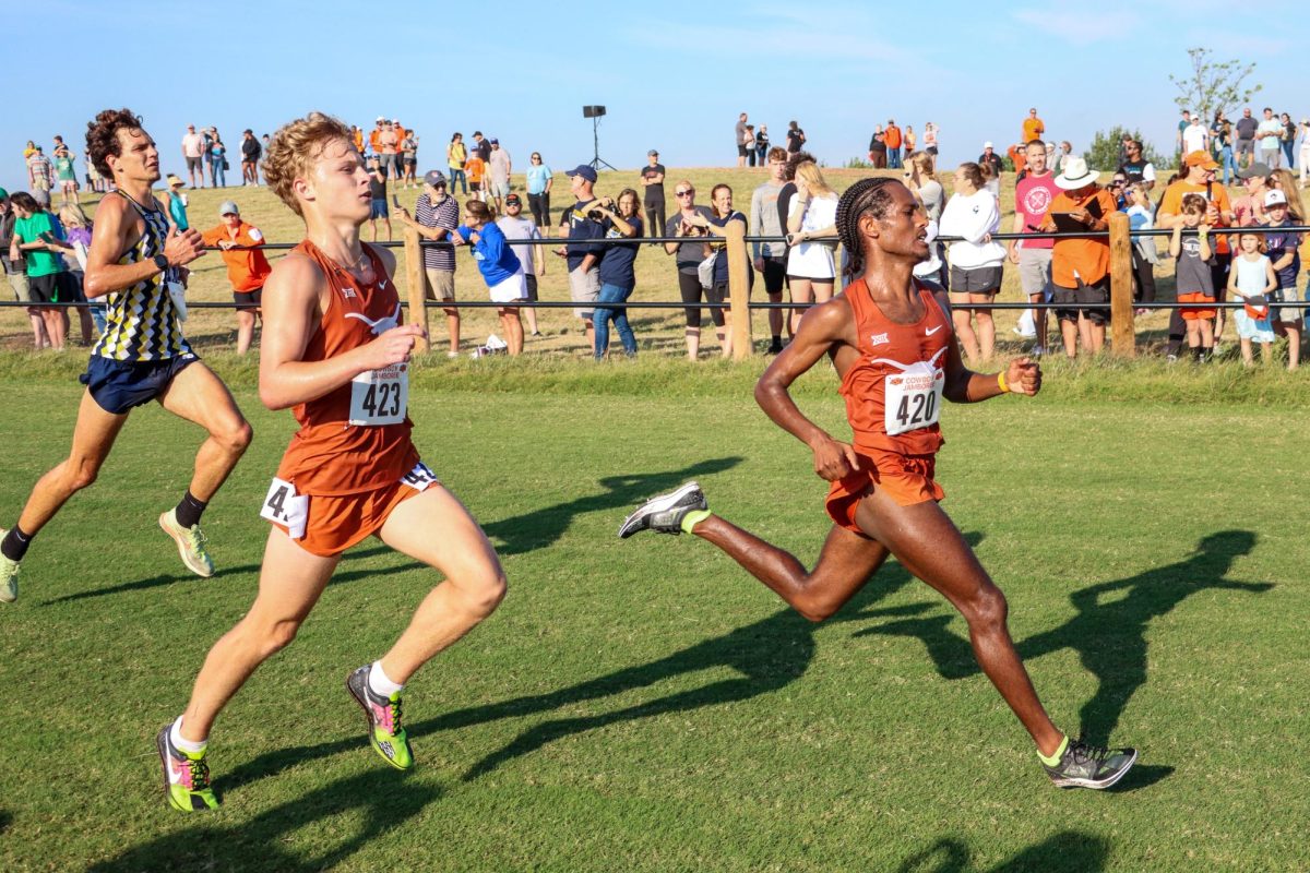 Sophomores Hudson Heikkinen and Nigusom Knight speed past an opponent in the last 200 meters of the Cowboy Jamboree 8K race. Heikkinen and Knight placed 29th and 28th, respectively.