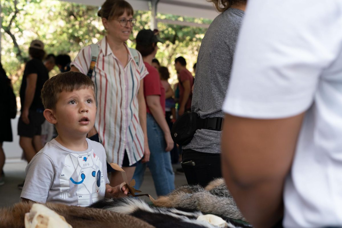 A child learns about the different kinds of fur on animals on the patio outside the Texas Science & Natural History Museum on Sept. 23, 2023. The museum had it’s grand re-opening event after being closed for 18 months for renovations.