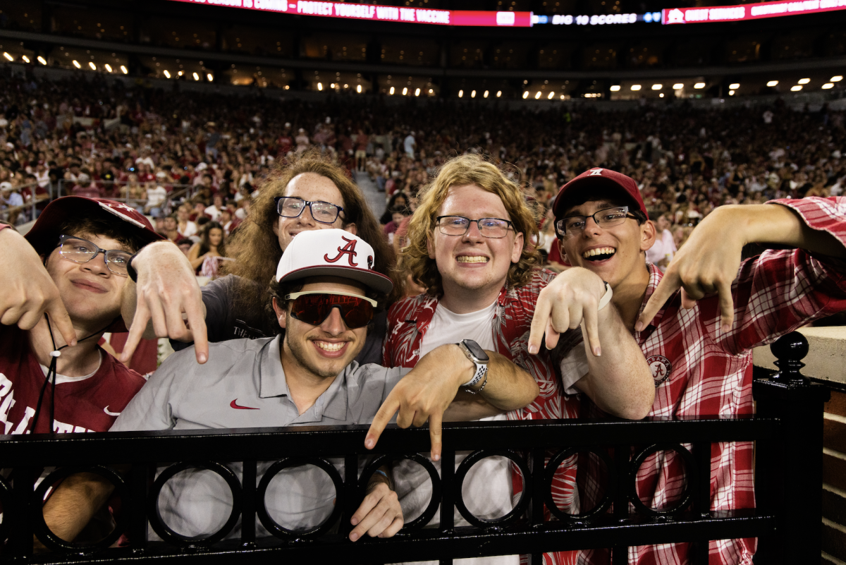 Alabama fans during the Longhorns' game against the Crimson Tide on September 9, 2023. Their gesture is commonly referred to as a "Horns Down."