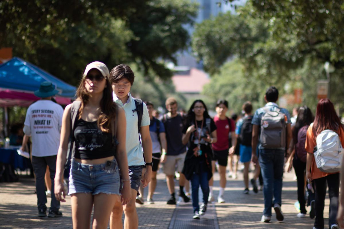  As the temperature rises mid-morning, the trees along the Speedway Mall keep students cool on their way to class on Sep. 1, 2023.