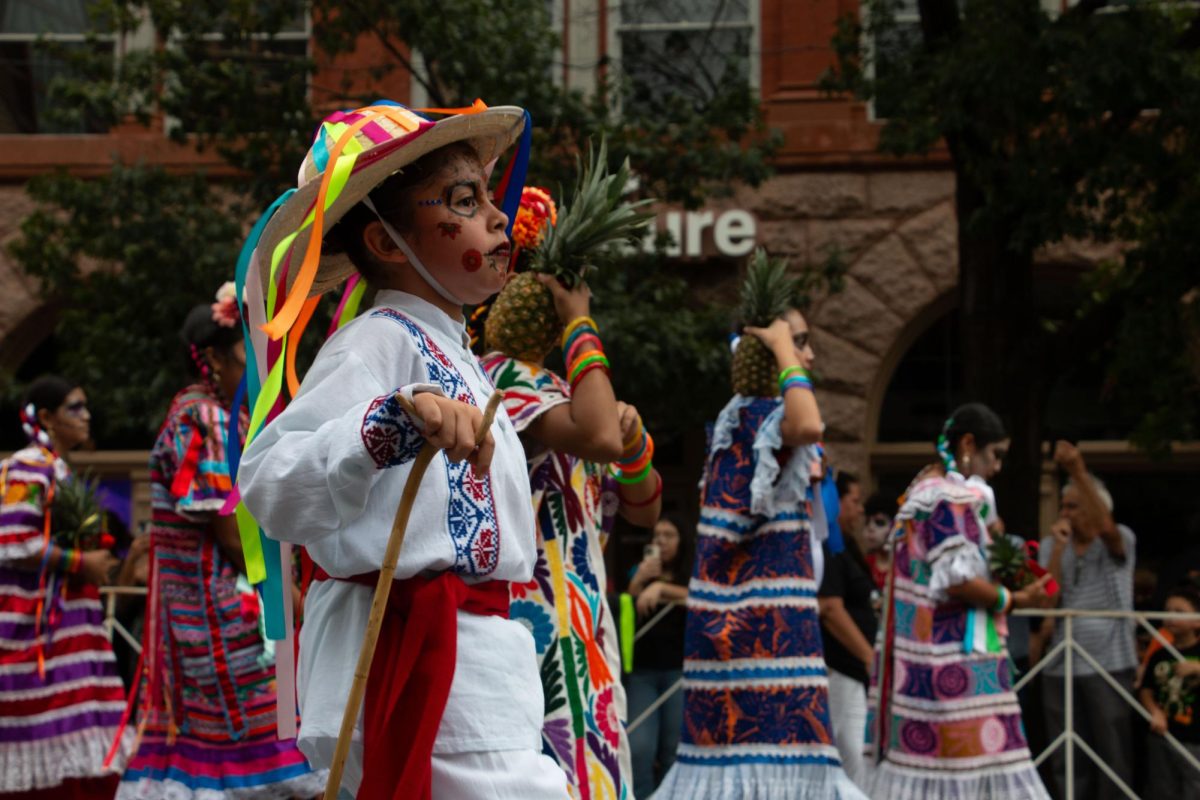 A group passes through during the 40th annual Viva la Vida Parade in celebration of Día de los Muertos on Oct. 28, 2023 in downtown Austin, Texas.