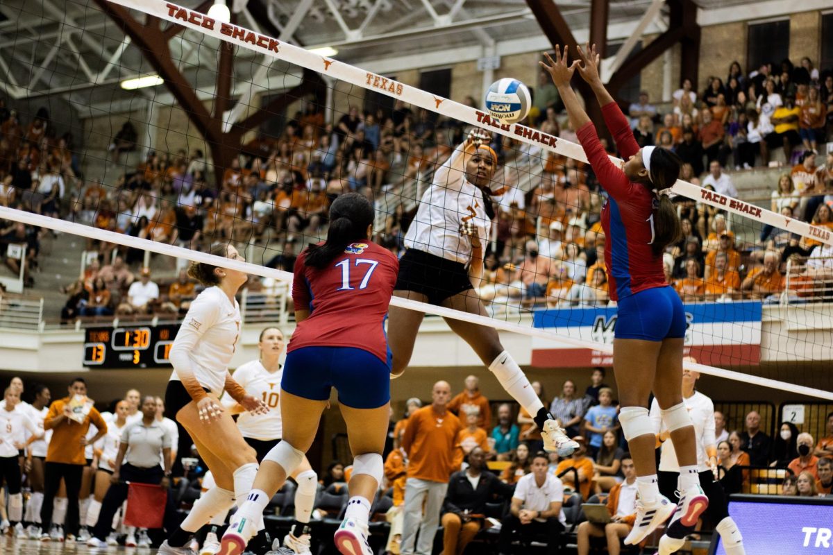 Asjia O’Neal spikes the ball towards the Kansas volleyball team on Oct. 5, 2023 in Gregory Gym. Texas won in four sets against the Jayhawks.