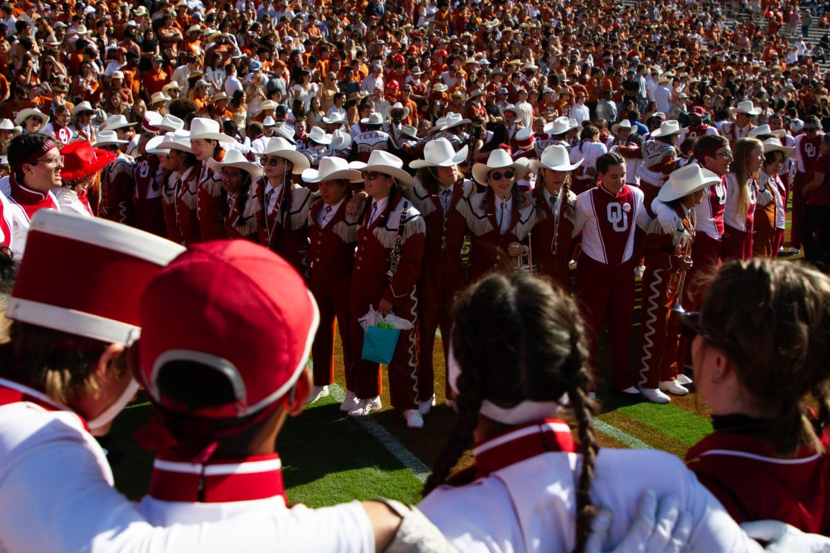 The Longhorn and Sooner bands huddle together before kickoff during Texas' game against OU on Oct. 7, 2023.