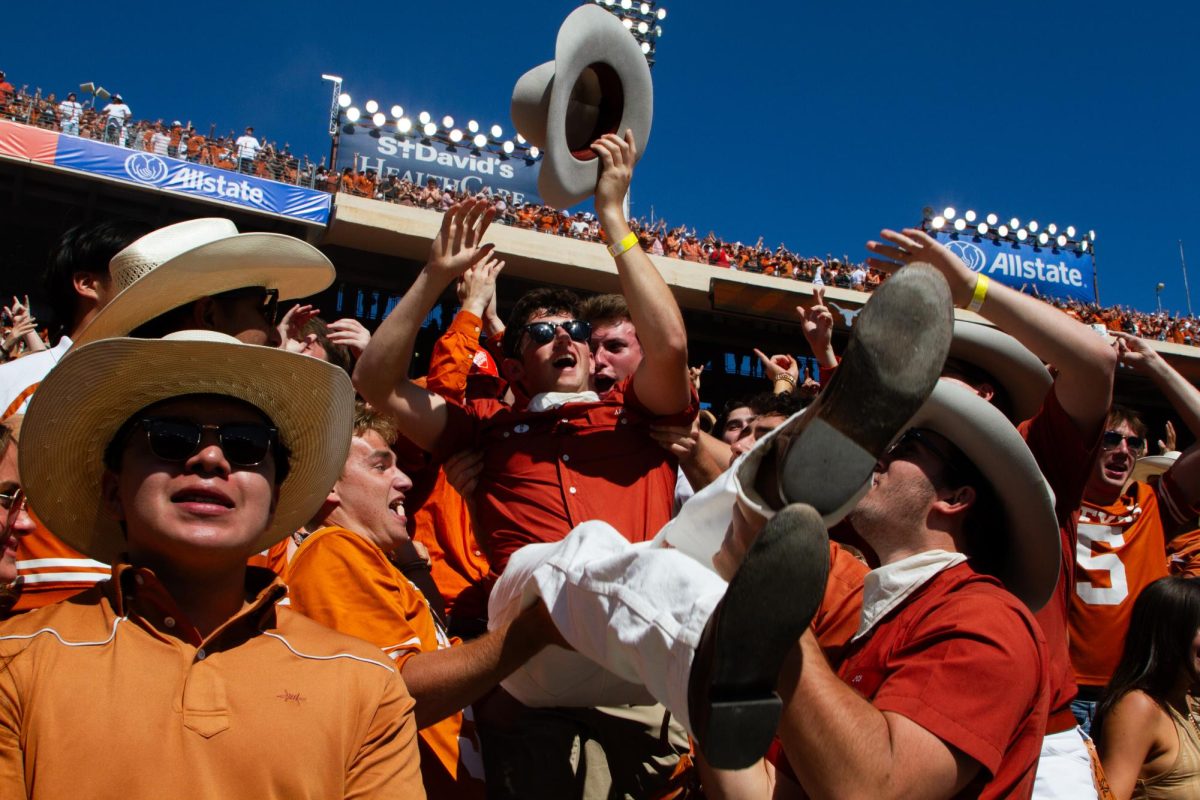 iMPA junior Aidan Cogan celebrates with friends after a Texas touchdown during UTs game against OU on Oct. 7, 2023.