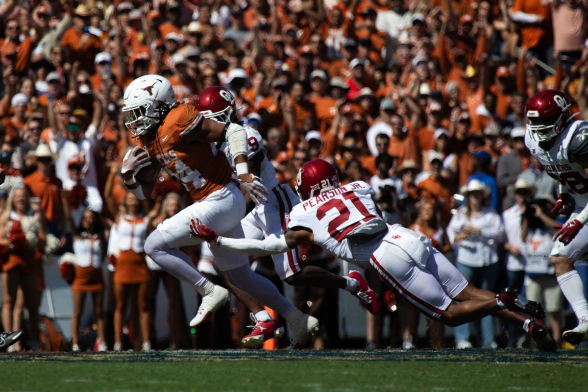 Running back Jonathon Brooks dodges a tackle during Texas game against Oklahoma on Oct. 7, 2023.
