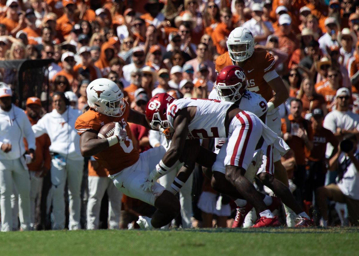 Tight end JaTavion Sanders is tackled during Texas game against OU on Oct. 7, 2023.