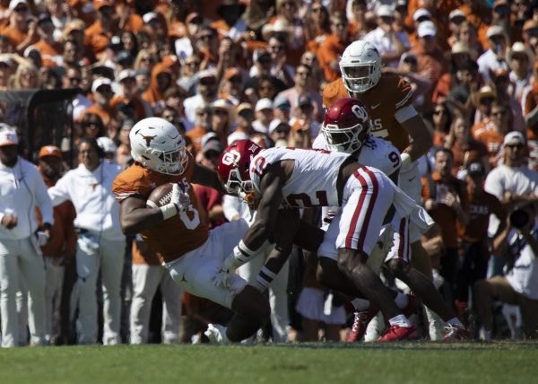 Tight end JaTavion Sanders is tackled during Texas game against Oklahoma on Oct. 7, 2023. The Longhorns lost to the Sooners 34-30 during the annual Red River Rivalry Game. 