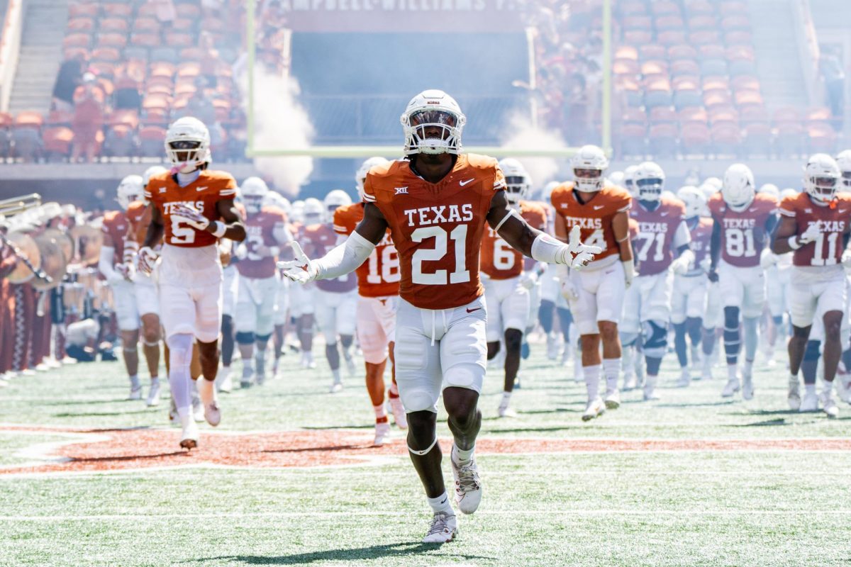 Senior defensive back Kitan Crawford runs out with the Texas Longhorns before their game against Kansas on Sept. 30, 2023.